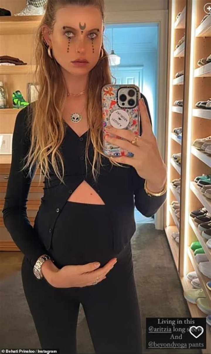 Behati Prinsloo Cradles Baby Bump In Cropped Cardigan For Halloween After Adam Levine Drama