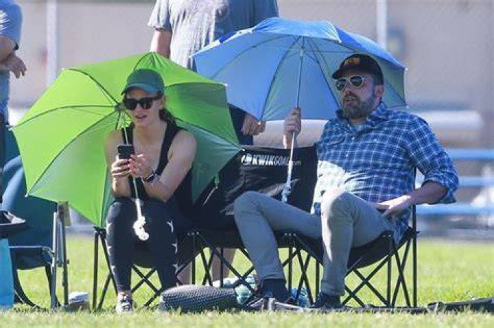 Ben Affleck & Jennifer Garner Shade Themselves With Umbrellas As They Watch Daughter’s Soccer Practice Together