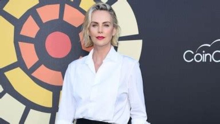 Charlize Theron, 45, Stuns In Black Mini Skirt & Sexy Red Lip As She Hosts ‘F9’ Screening