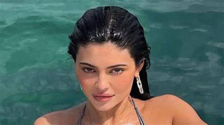 Kylie Jenner Lounges By the Pool in Black String Bikini: ‘Home Away From Home’